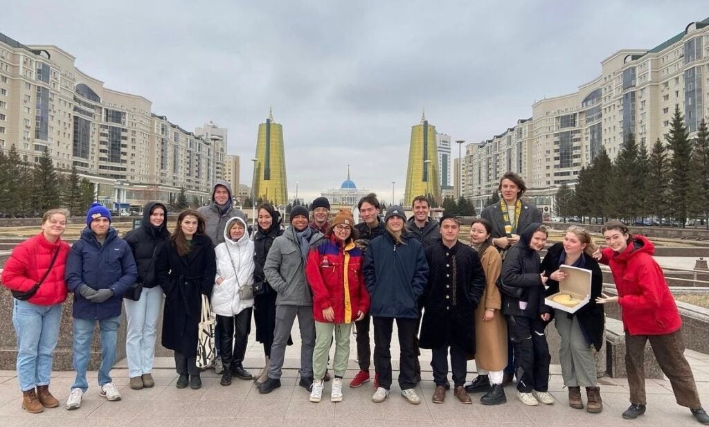 A group of students stands in the main square in central Almaty, Kazakhstan.